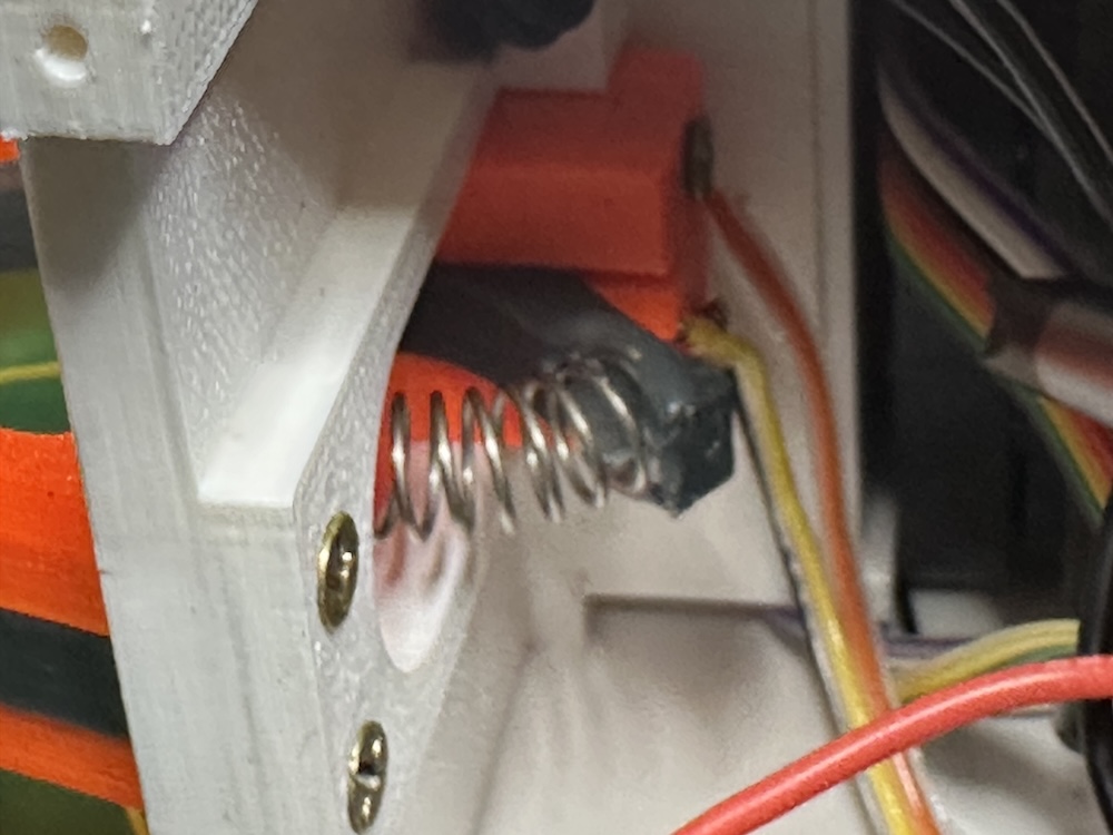 The trigger uses a spring for pressure. Then it presses a switch.